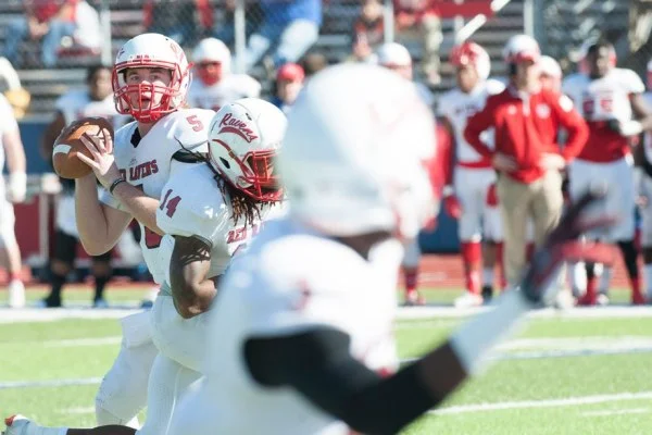 quarterback throwing football pass